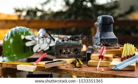 Carpenter's square, carpentry tools on a work table. Construction industry, housework do it yourself. Stock photography.