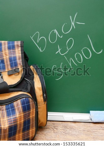School bag against a school board. Back to school.