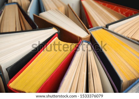 Stack of hardcover books as background, closeup
