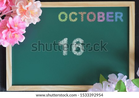 October month write with colorful chalk, flowers on the board, Date 16.