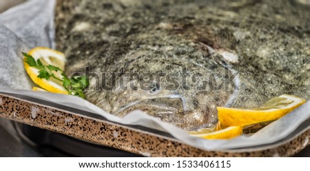 Brill fish on the kitchen with lemon.