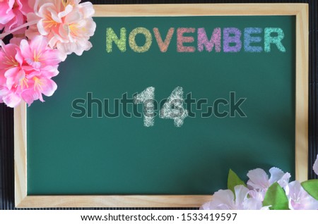 November month write with colorful chalk, flowers on the board, Date 14.
