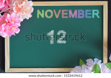 November month write with colorful chalk, flowers on the board, Date 12.