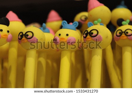 A collection of small dolls in the form of smiling yellow faces