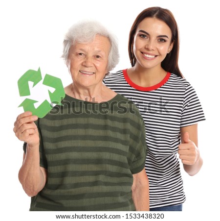 Elderly woman and her granddaughter with recycling symbols on white background
