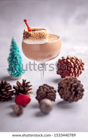 Delicious festive cocktail with chocolate served in a coupette with a torched marshmallow.