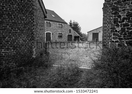 Old farm house and sheds in Belgium, region Liege nearby Gemmenich  and Sippenaeken, picture taken in black and white