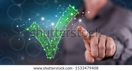 Man touching a validation concept on a touch screen with his finger Royalty-Free Stock Photo #1533479408
