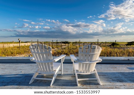 Beach chair on Cape Cod beach at sunset, Cape Cod, Massachusetts, USA.