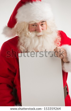 Santa Claus holding white blank sign with smile
