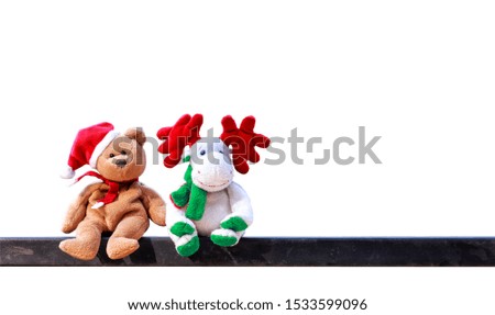 Christmas symbol doll. Teddy bears wearing Santa's hats and reindeer doll isolated on white background with clipping path.