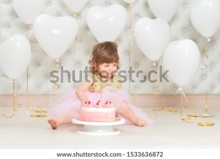 baby girl with cake on her birthday