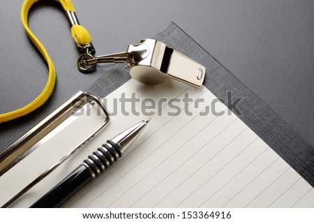 Metal sport whistle with pen and paper sheet Royalty-Free Stock Photo #153364916