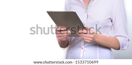 Tablet in the hands of a girl in a shirt. Stand-alone photo. Business photography