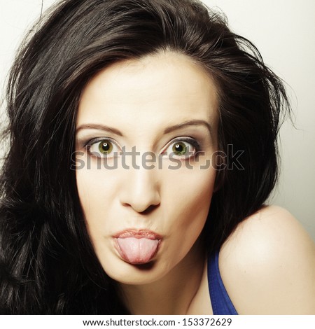 portrait picture of teenage girl sticking out her tongue
