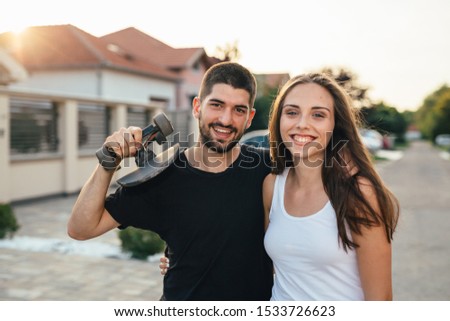 happy couple outdoor riding skateboard