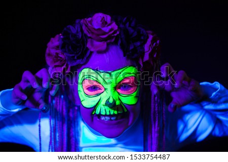 Light hair girl with African brides posing with neon face painting. Skeleton shape Royalty-Free Stock Photo #1533754487