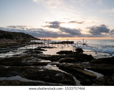 
Rocky beach by the sea at dawn in Cabo de Huertas Alicante