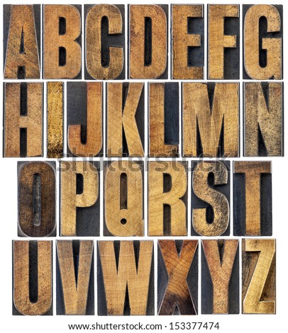 complete English alphabet - a collage of 26 isolated vintage wood letterpress printing blocks, scratched and stained by ink Royalty-Free Stock Photo #153377474