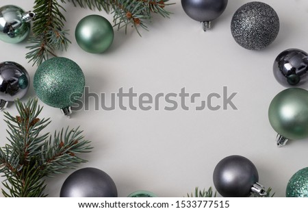 Christmas tree decorations on a white background. In the photo are turquoise and silver balls. New Year photo.