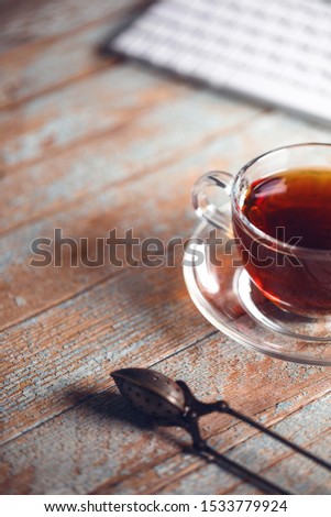Tea with notebook on the wooden table