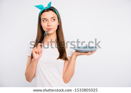 Close-up portrait of her she nice attractive lovely pensive girl holding on palm plate licking fork guessing recipe ingredients menu isolated over light white color background Royalty-Free Stock Photo #1533805025