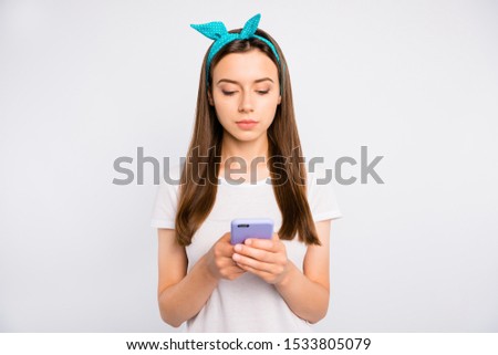 Portrait of focused serious girl use her cellphone read information in social media account wear casual style outfit isolated over white color background