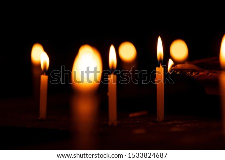 Diwali decorations - candles are lighted up by a clay oil lamp. Background concept for indian religious tradition culture, temple, church, worshiping, praying, believer.