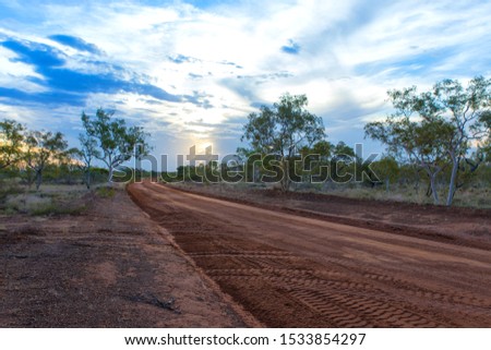 gravel road in the Australian desert at sunset