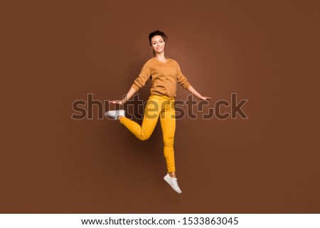 Full length body size photo of toothy cute fascinating gorgeous girl jumping up having gone on vacation and being able to do nothing isolated over brown pastel color background
