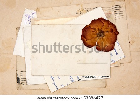 old letters, empty post cards and dried rose, vintage background