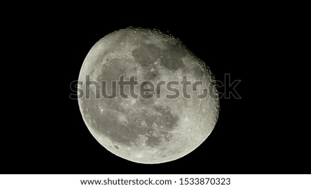 A picture of the moon in the sky of the city
