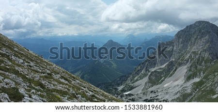 Panoramatic picture of high peaks of austrian alps from mountain Scheblingstein with brown chamois on the left. On the right side is moutain called Grosser Pyhrgas.