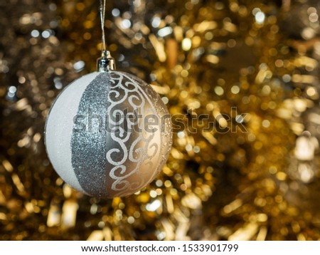 Christmas balls on a background of lights and bright beautiful  tinsel. Christmas design card with place for text. Xmas decorations. 

Good New Year spirit. 