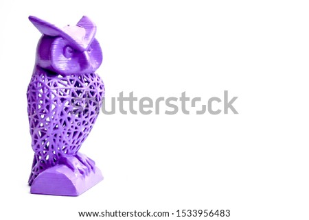 Owl created using 3D printer, openwork sculpture of purple color.