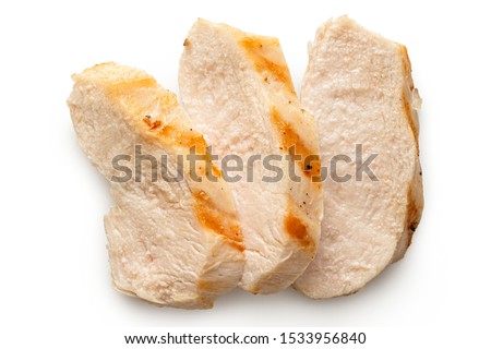 Three slices of grilled chicken breast with grill marks isolated on white. Top view. Royalty-Free Stock Photo #1533956840