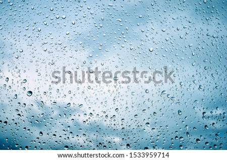Raindrops on glass on a cloudy day. Rain outside the window.