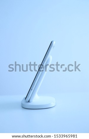 Mobile phone on wireless charging stand