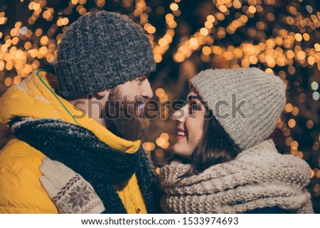 Profile photo of two people guy lady kissing outside lights midnight park newyear evening stand opposite snowy weather wear winter coats scarfs hats outdoors