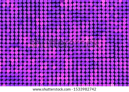 Shiny lilac and purple sequins. Abstract background. Closeup.