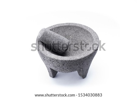 Stone molcajete used to grind vegetables and prepare typical Mexican foods Royalty-Free Stock Photo #1534030883