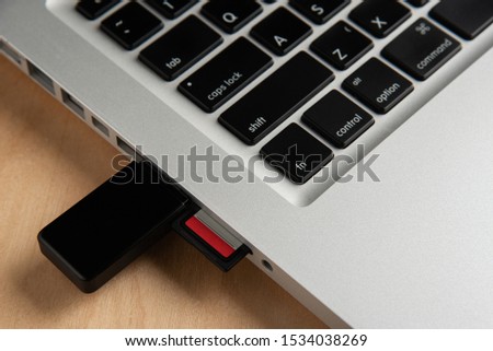 Close up of sd card card reader inserted in laptop