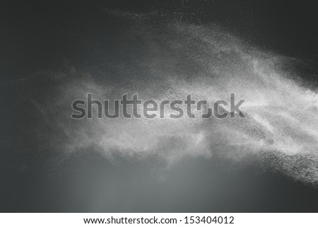 Abstract design of white powder cloud against dark background Royalty-Free Stock Photo #153404012