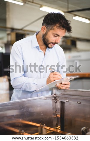 The engineer oversees the process of working in an electrical workshop,stock photo