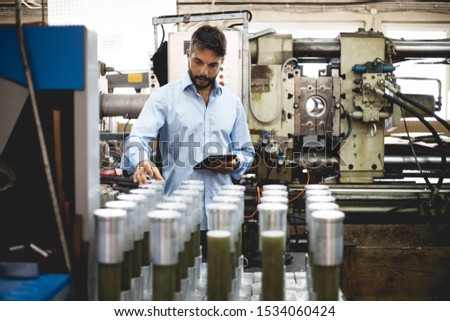 The engineer oversees the process of working in an electrical workshop,stock photo
