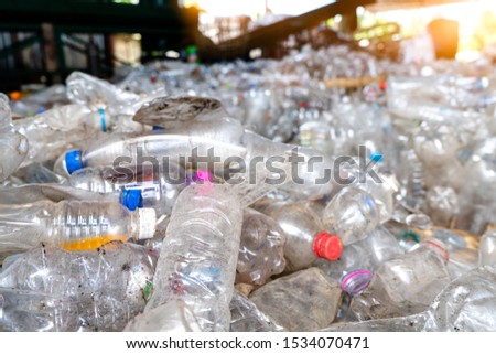 recycled plastic bottles are placed on the floor waiting to be recycled. at plastic factory