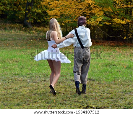 Two in the park dancing in autumn