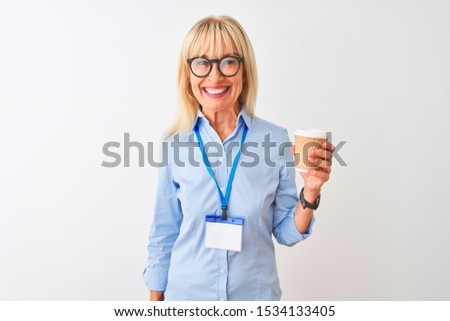 Businesswoman wearing glasses and id card drinking coffee over isolated white background with a happy face standing and smiling with a confident smile showing teeth