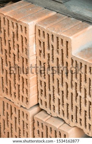 close-up of pack of orange clay bricks stands near the construction site. Clay brick is an ecological building material. 