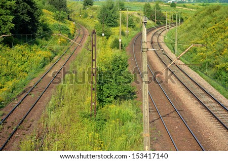 Three railway tracks and power lines